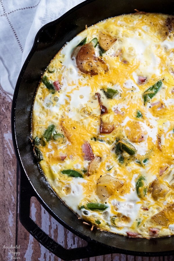 Ham, Asparagus, and Potato Frittata in a cast iron skillet.