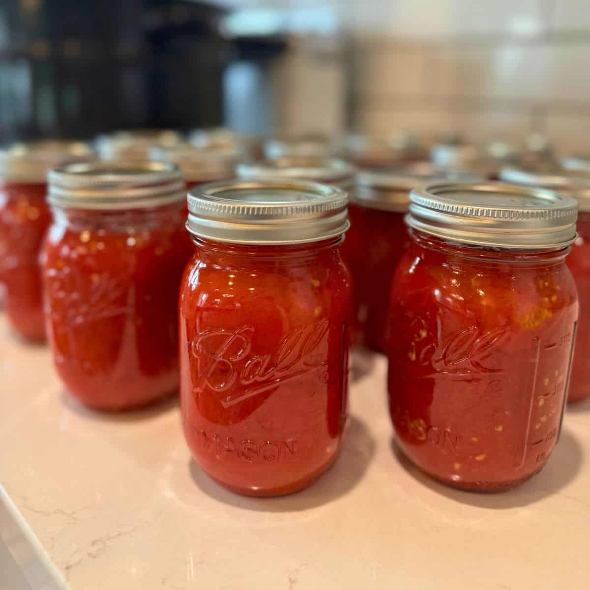 home canned crushed tomatoes in pint jars on counter